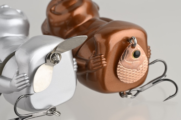 Silver and Bronze Billiken Lures fitted with blades and fish-shaped custom parts