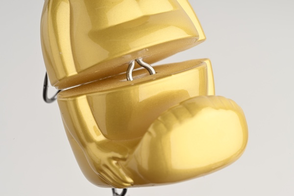 Gold Billiken Lure showing the joint that connects its upper and lower body